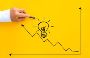 Businessman pointing lightbulb and arrow growth with pen. Business start-up goals to success and id