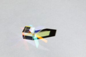 Glass geometric figures prisms with light diffraction and shadows