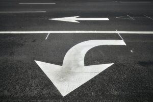 Turn or go straight street signs on asphalt.